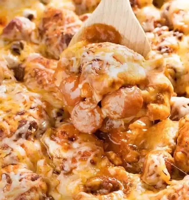 Delicious chili dog casserole baked with biscuits and topped with cheese