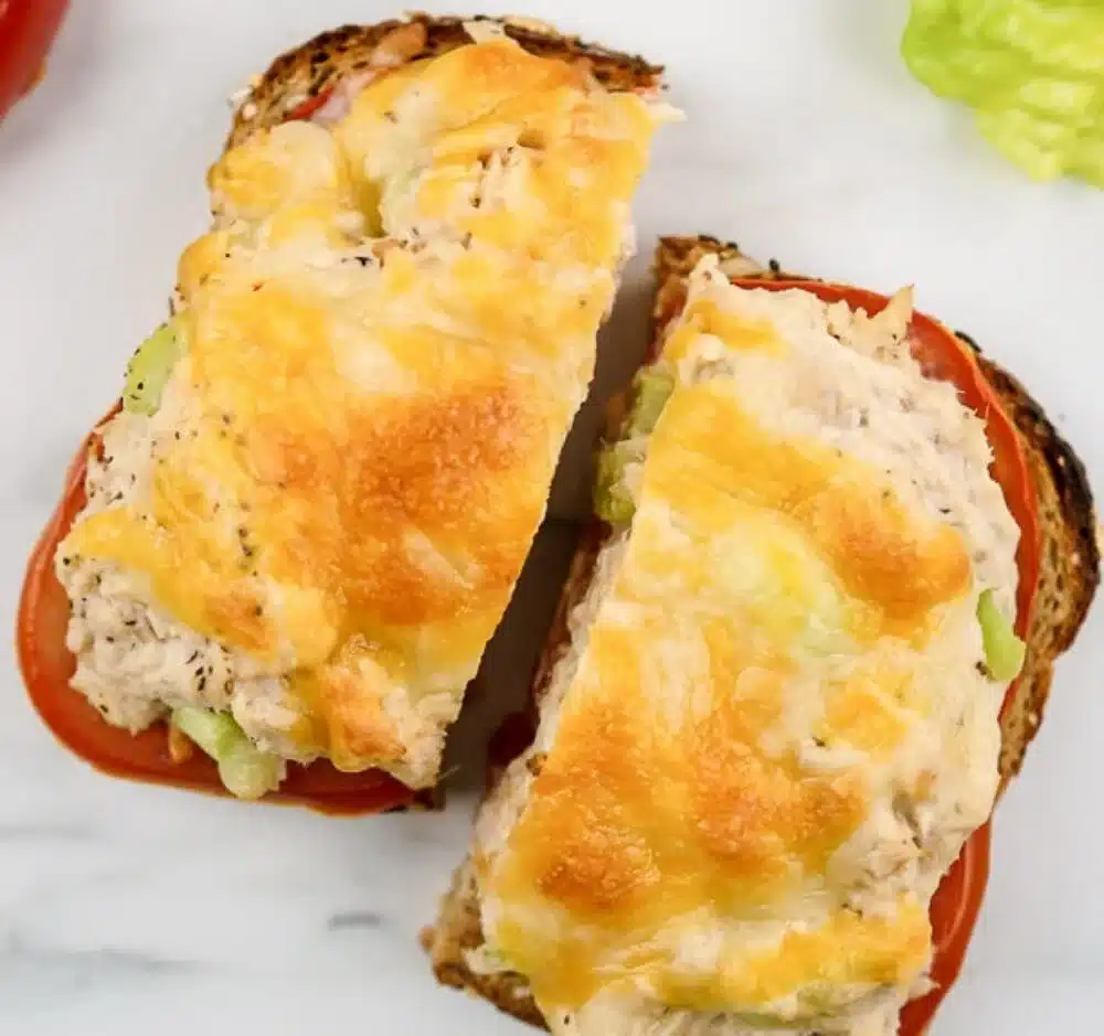Healthy lightened up tuna melt with avocado and salad, served on toast.