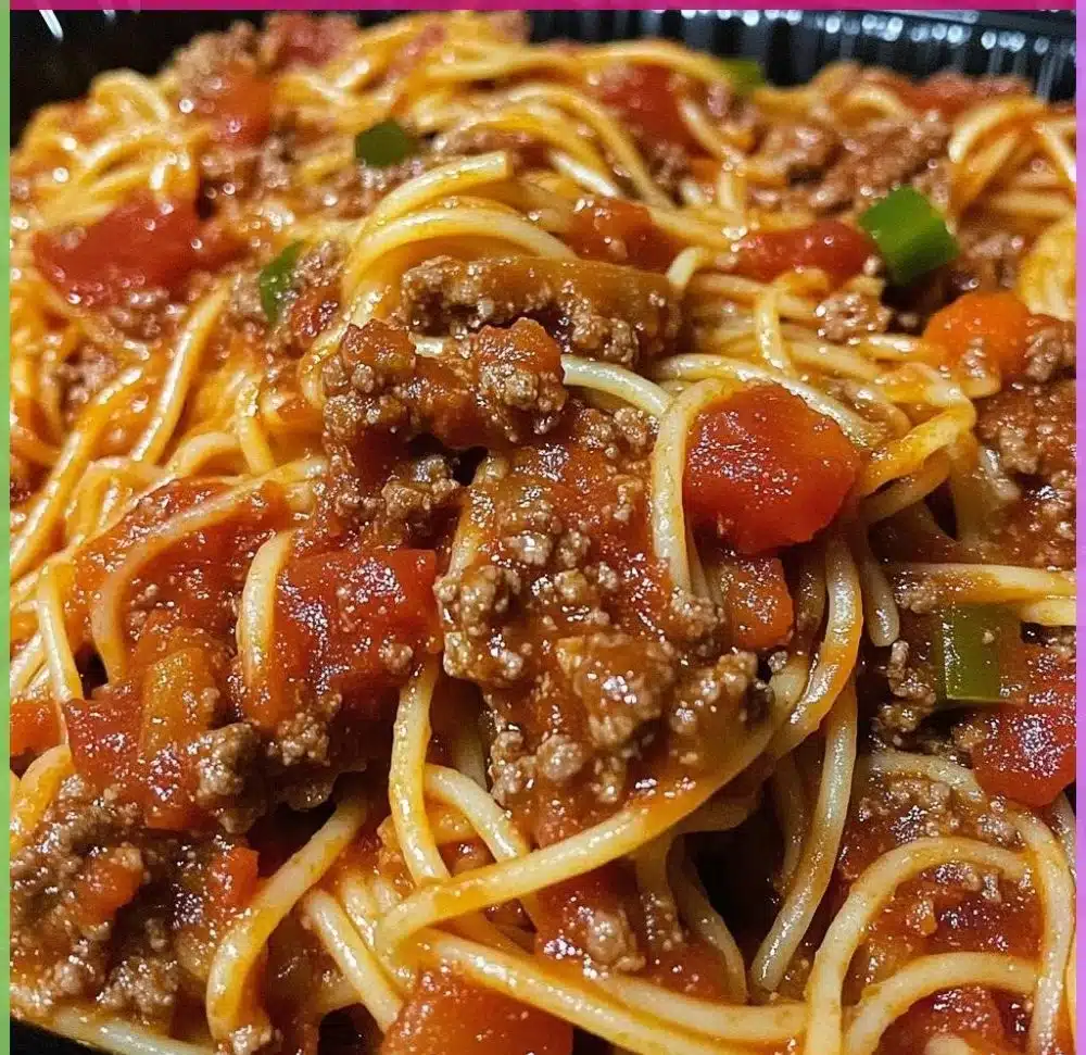 Old-fashioned spaghetti dish garnished with fresh herbs and tomatoes